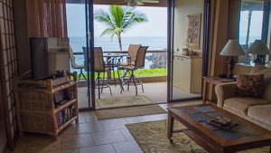 The condo features a open living room setting with an ocean view.